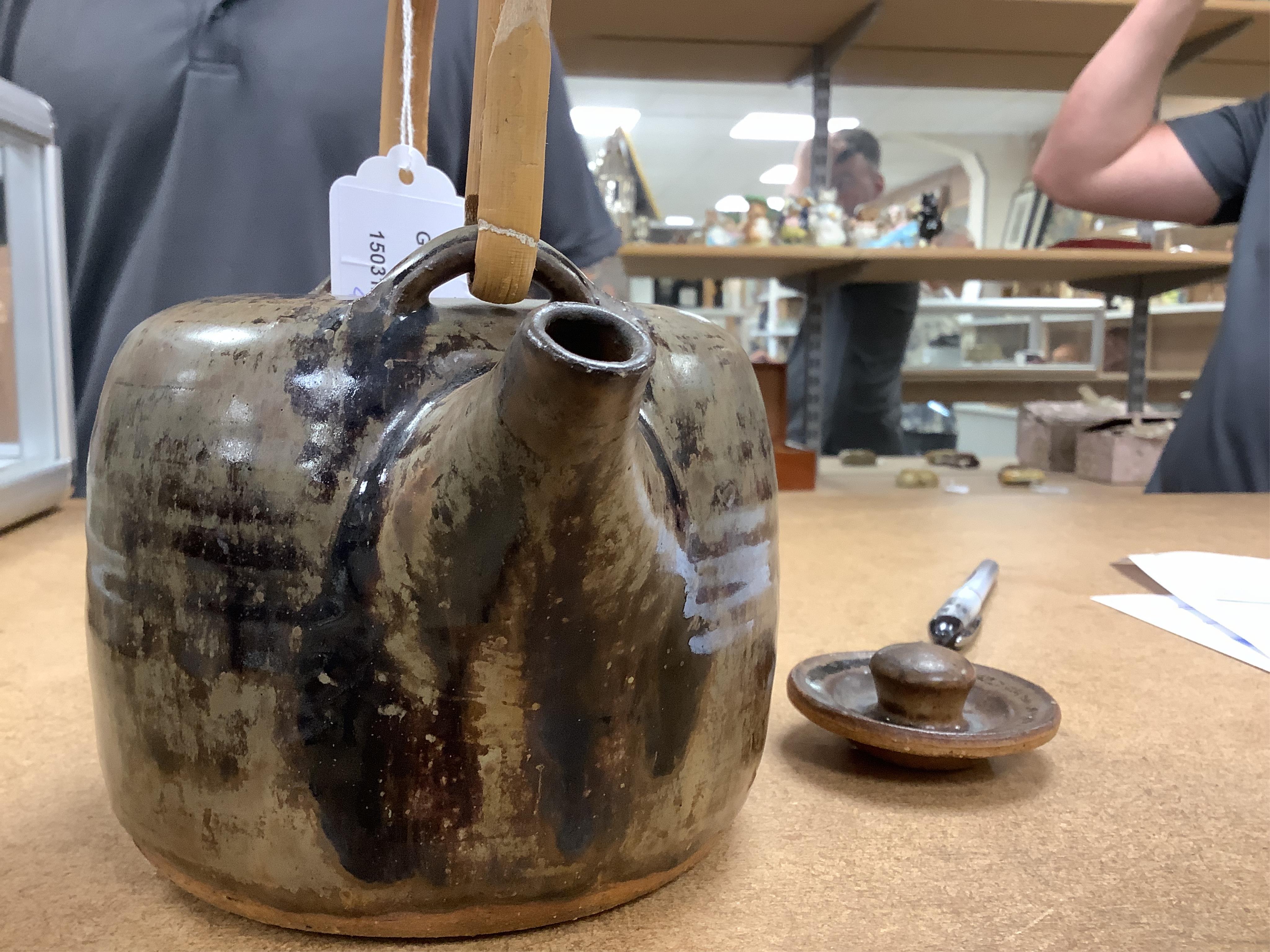 Pierre Culot (Belgian, 1938-2011), a studio pottery teapot with bamboo handle, stamped to the foot rim, 23cm high. Condition - fair to good, minor chipping